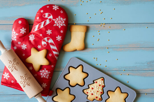 Christmas cookies and baking utensils festive holiday baking concept on a blue wooden background - Powered by Adobe