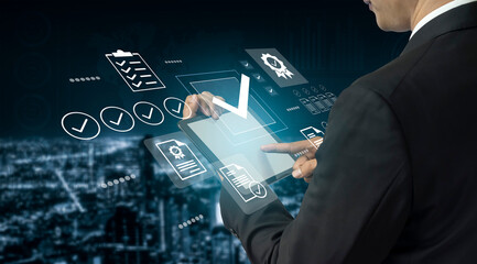 A businessman interacts with a tablet, displaying holographic data icons in a high-tech urban setting, symbolizing innovation and modern analysis tools in business. Gantry