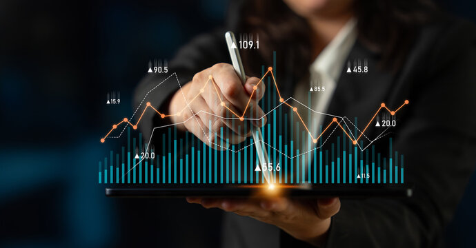A business professional uses a digital tablet to analyze financial data trends, showcasing graphs and statistics for modern analytics and insightful reporting. Scalp - Powered by Adobe