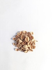 A pile of pistachio shells on a white background