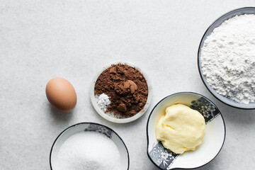 mise en place of ingredients for making chocolate cake, top view of chocolate cake ingredients