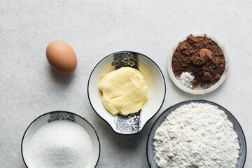 mise en place of ingredients for making chocolate cake, top view of chocolate cake ingredients
