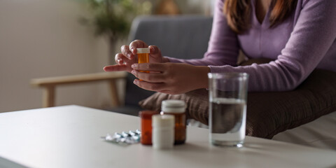 Fototapeta premium Medication Management. Woman holding prescription bottle, contemplating health.