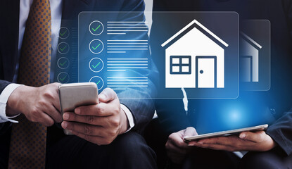 Two business professionals engage in a discussion about real estate investments, using smartphones and tablets in a modern office environment with digital icons. Gantry