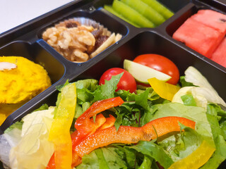 Healthy Meal Box with Fresh Salad, Fruits, and Nuts