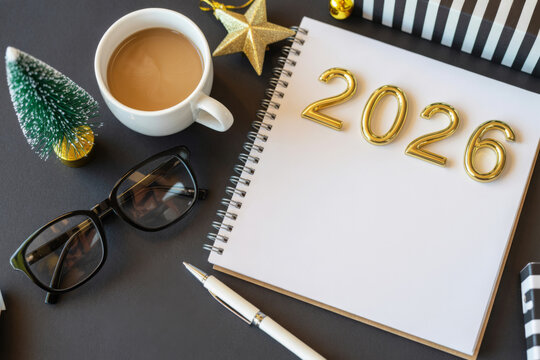 Festive 2026 New Year composition featuring a notebook coffee and decorations perfect for planning and celebration concepts