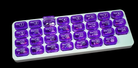 Rectangular pill organizer with 31 compartments, each labeled for a day. Monthly medication management