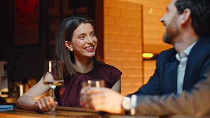 Laughing pair joking together resting bar at evening closeup. Couple flirting