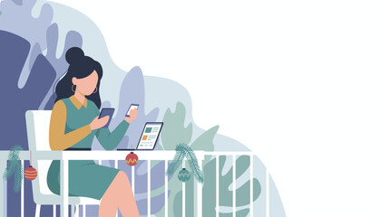 A woman works remotely on a balcony using multiple devices during the winter holidays