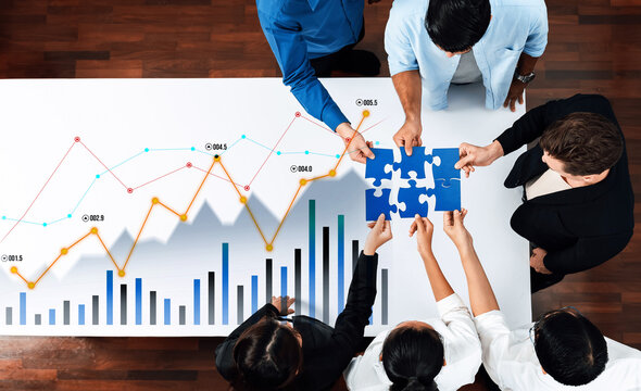 A diverse group of professionals collaborates on data analysis using charts and puzzles, showcasing teamwork and innovative problem-solving in a modern office setting. Scalp - Powered by Adobe