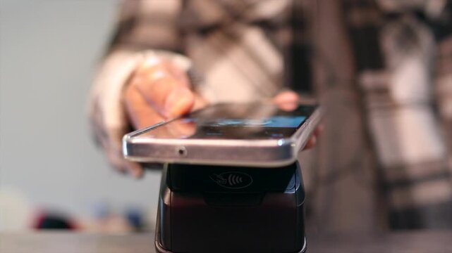 Person uses mobile payment for shopping transaction.