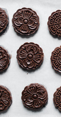 Overhead view of stamped chocolate cookies on a parchment lined tray