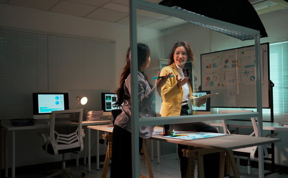 Businesswomen collaborating on data analysis during office overtime at night - Powered by Adobe