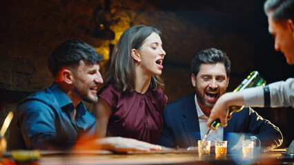 Party group jumping together in loft dark cafe closeup. People clinking shots