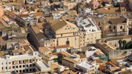 Fototapeta premium Aerial view of houses, roofs, and buildings in Ortygia. This is the historic center of Syracuse, Sicily, Italy. 