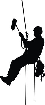 Silhouette of window washer rappelling down building