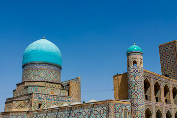 Uzbekistan architecture in Samarkand and Bukhara with intricate mosaics blue domes ancient madrasas Islamic patterns historic monuments vibrant tilework and cultural heritage in bright daylight