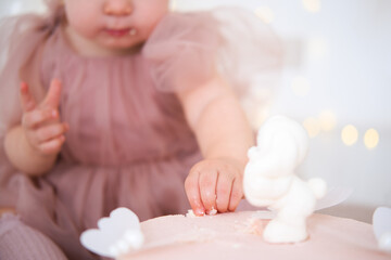 close-up of a baby trying her first birthday cake