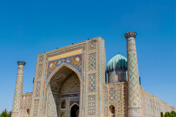 Uzbekistan architecture in Samarkand and Bukhara with intricate mosaics blue domes ancient madrasas Islamic patterns historic monuments vibrant tilework and cultural heritage in bright daylight
