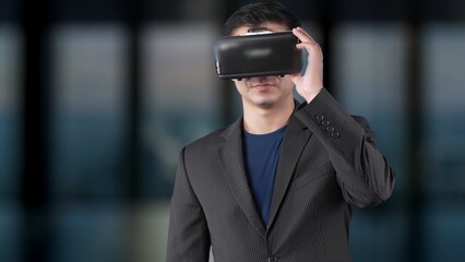 A professional man wearing a VR headset symbolizes the intersection of technology and business. His...