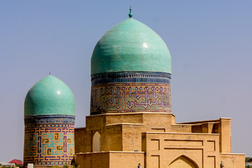 Uzbekistan architecture in Samarkand and Bukhara with intricate mosaics blue domes ancient madrasas Islamic patterns historic monuments vibrant tilework and cultural heritage in bright daylight