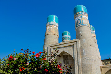 Uzbekistan architecture in Samarkand and Bukhara with intricate mosaics blue domes ancient madrasas Islamic patterns historic monuments vibrant tilework and cultural heritage in bright daylight