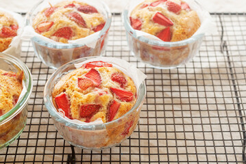 freshly baked homemade strawberry muffins place on a cooling rack.