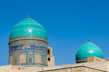 Uzbekistan architecture in Samarkand and Bukhara with intricate mosaics blue domes ancient madrasas Islamic patterns historic monuments vibrant tilework and cultural heritage in bright daylight