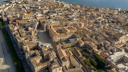 Fototapeta premium Aerial view of the island of Ortygia. This is the historic center of Syracuse, Sicily, Italy. The city overlooks the Mediterranean Sea and contains many historical landmarks. It's a summer morning.
