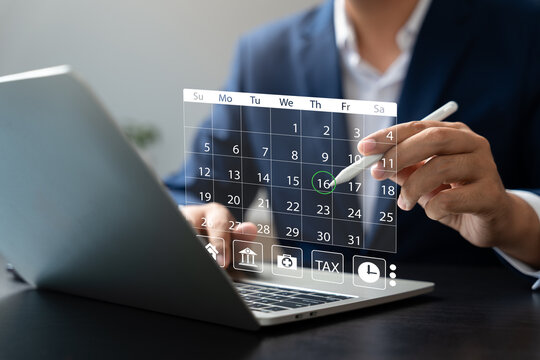 Businessman managing schedule with digital calendar interface on laptop using stylus pen, representing time management, event planning, productivity, and online appointments.
