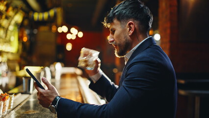 Elegant businessman resting bar with cocktail closeup. Rich man meeting friend