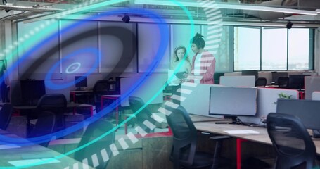 Talking two coworkers in business attire viewing tablet at open office with AR overlay, copy space