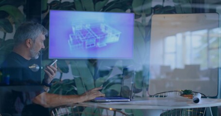 Holding phone to mouth, dark short-sleeve man using laptop in glass room with screen, copy space