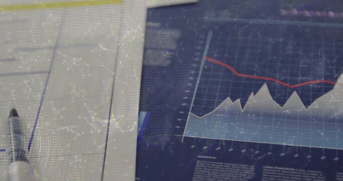 Displaying tablet showing downward trend chart at office desk, with forms, pen, overlay, copy space