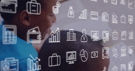 Leaning boy in bright blue top watching tablet at school, with overlaid business icons, copy space