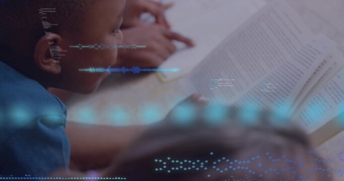 Leaning boy in blue shirt reading at classroom table, open book and pencil visible, copy space