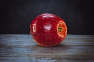 red apple on wooden table