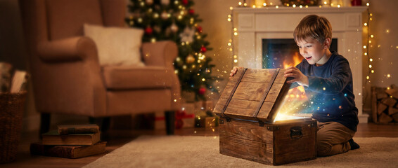 Treasure of Joy: A young boy opens a vintage wooden chest, revealing a magical and wondrous glow, a moment of childhood excitement during festive season. Christmas banner, blank space