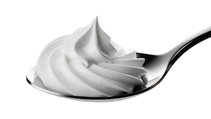 Whipped topping swirls elegantly on a silver spoon
