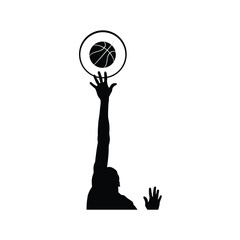 Silhouette of basketball player reaching to score with ball