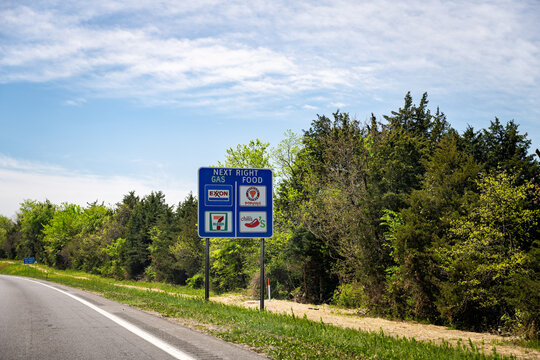 Warrenton, USA - April 27, 2025: Virginia highway 29 south and blue sign for exit 7 eleven exxon gas and chili's popeyes food
