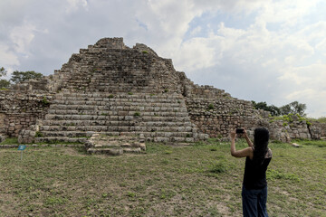 woman standing in front of ancient mayan pyramid ruins in the maya city of oxkintok in yucatan mexico (travel tourism photo blog adventure destination history tour getaway) steps historic monument