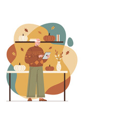 Elderly man using tablet among fall pumpkin decorations Cozy autumn technology and lifestyle