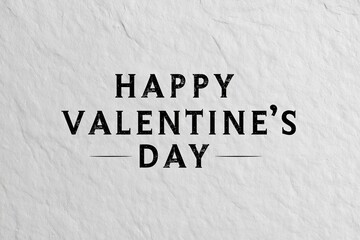 Happy Valentine's Day text in black serif font on a light gray textured surface. Classic typography for holiday greeting card or banner