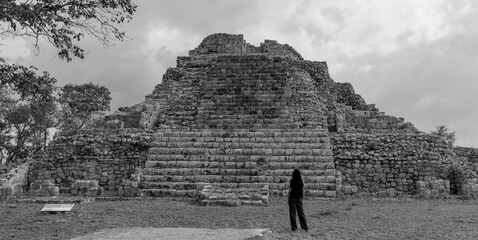 woman standing in front of ancient mayan pyramid ruins in the maya city of oxkintok in yucatan mexico (travel tourism photo blog adventure destination history tour getaway) steps historic monument