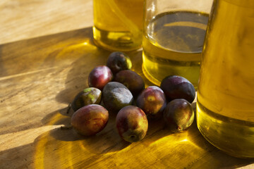 fresh olives and extra virgin olive oil in warm natural sunlight