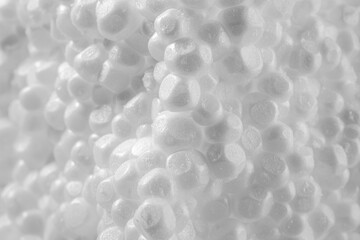 Macro shot of a piece of polystyrene foam. Extreme close-up view of the cross-section of a polystyrene part. Close-up view of a piece of styrofoam.