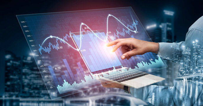 A businessman uses a futuristic laptop interface to analyze digital financial data and market trends in a vibrant urban setting at night, showcasing technology impact on finance. Scalp