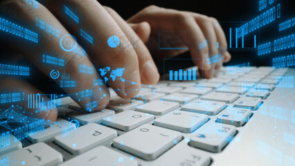 A person hands type on a keyboard, surrounded by floating digital elements and graphs, symbolizing technology and data interaction in a modern workspace. Xenic