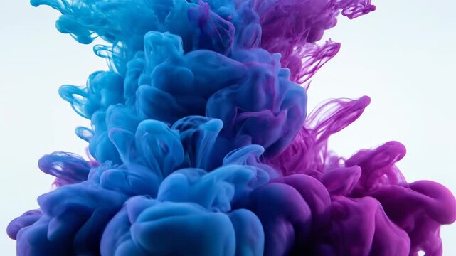 Slow motion macro shot of brilliant cyan and magenta liquid ink mixing and flowing dynamically in clear water creating a vibrant abstract background texture design, concept, deep